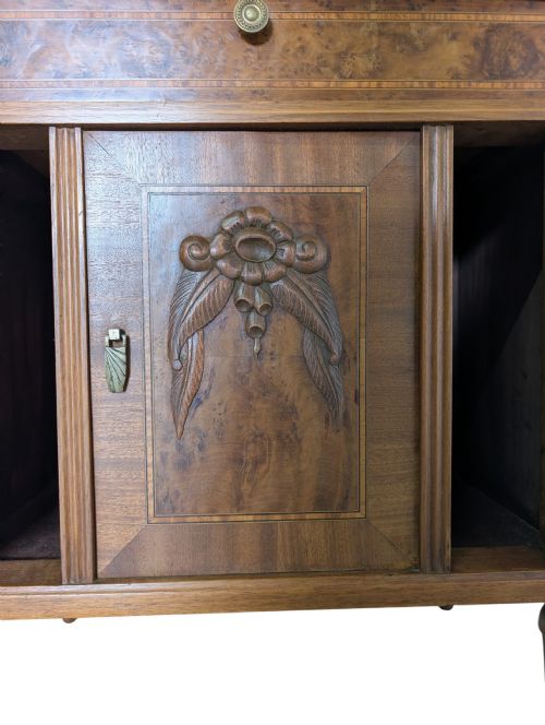 fig 2. An antique walnut bedside cabinet featuring a beige marble top, a single upper drawer with a brass knob, turned legs, and a central carved door.