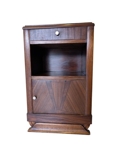 fig 1. A dark brown walnut Art Deco bedside cabinet featuring a top drawer, an open central shelf, a cupboard door with geometric veneer inlay, and hexagonal metal knobs.