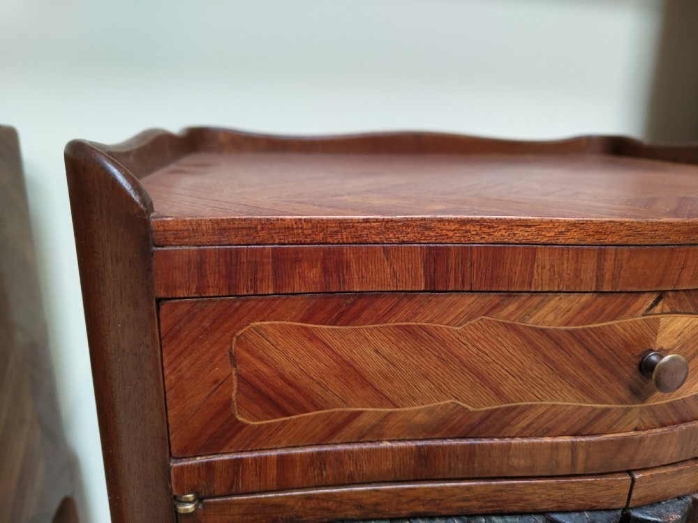 A pair of antique French-style inlaid wooden bedside cabinets featuring parquetry tops, curved cabriole legs with brass feet, and faux book spine doors. View VI