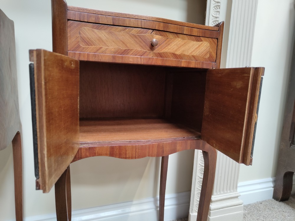 A pair of antique French-style inlaid wooden bedside cabinets featuring parquetry tops, curved cabriole legs with brass feet, and faux book spine doors. View VIII