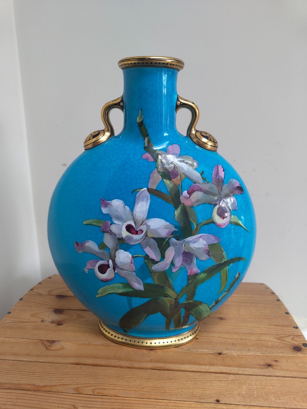 A turquoise porcelain vase featuring twin gilded handles, decorated with hand-painted orchid flowers and a crackle glaze finish. View XIV