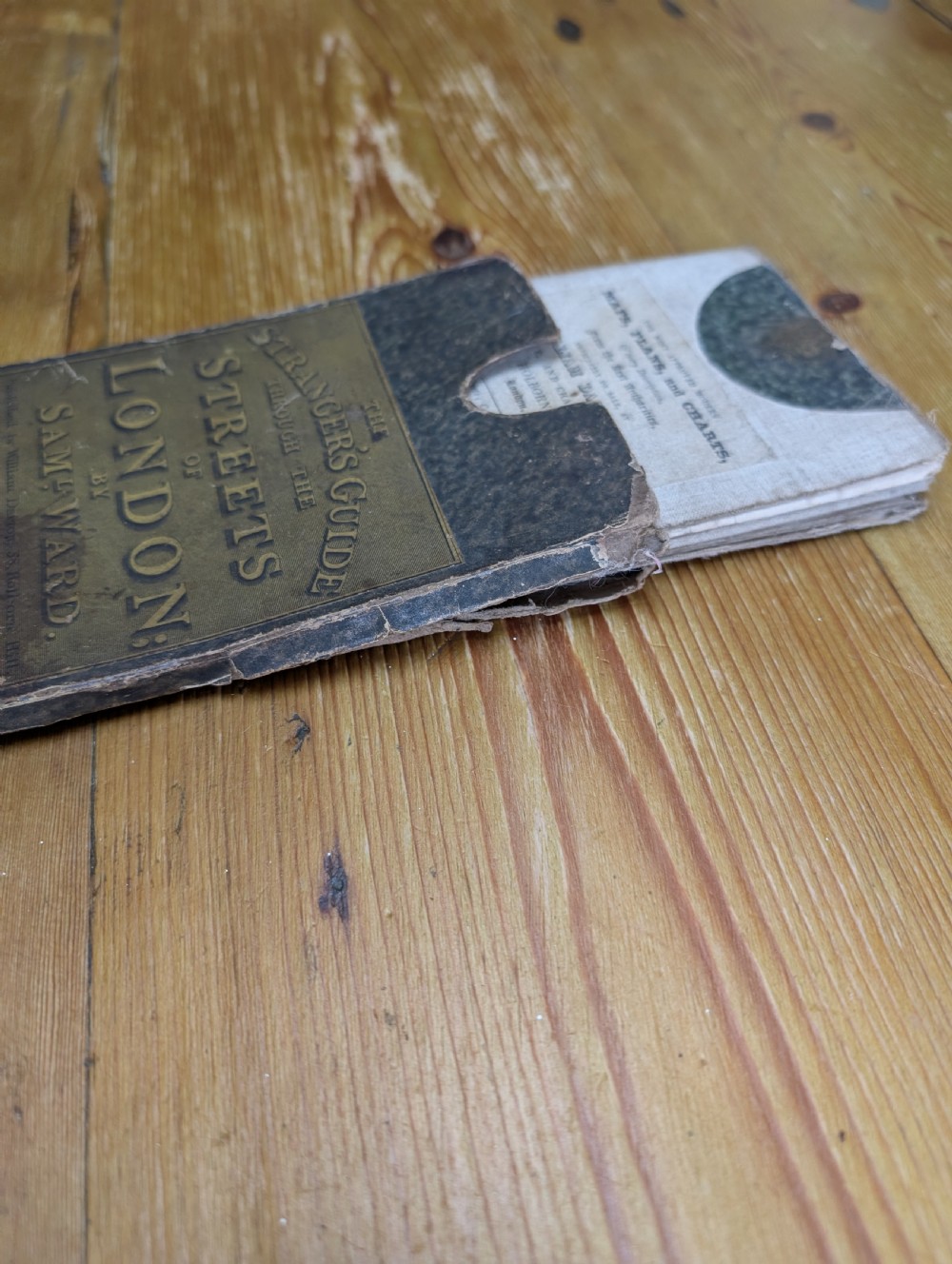 An antique printed paper pocket map of London in a dark slipcase titled The Strangers Guide Through the Streets of London by Saml. Ward. View III