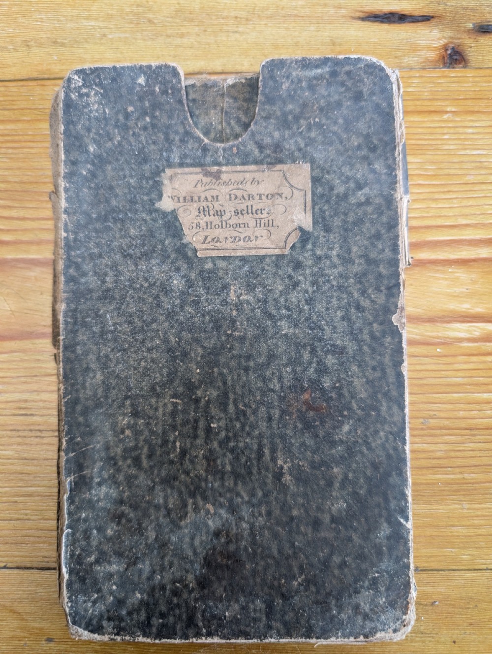 An antique printed paper pocket map of London in a dark slipcase titled The Strangers Guide Through the Streets of London by Saml. Ward. View XI