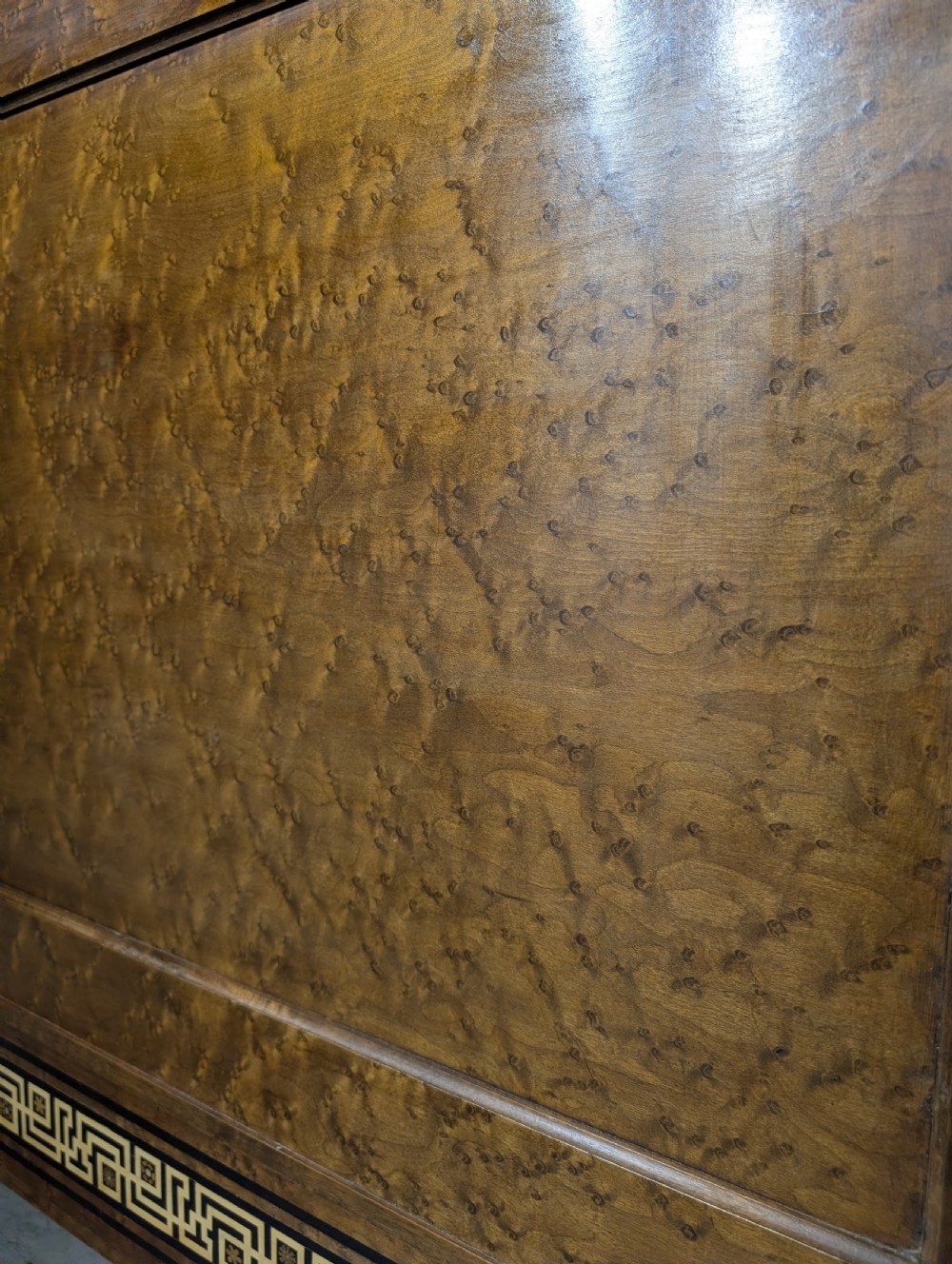 An Empire style king-sized bedstead crafted in golden veneered wood with gilt mounts and a Greek key border along the footboard base. View XIV
