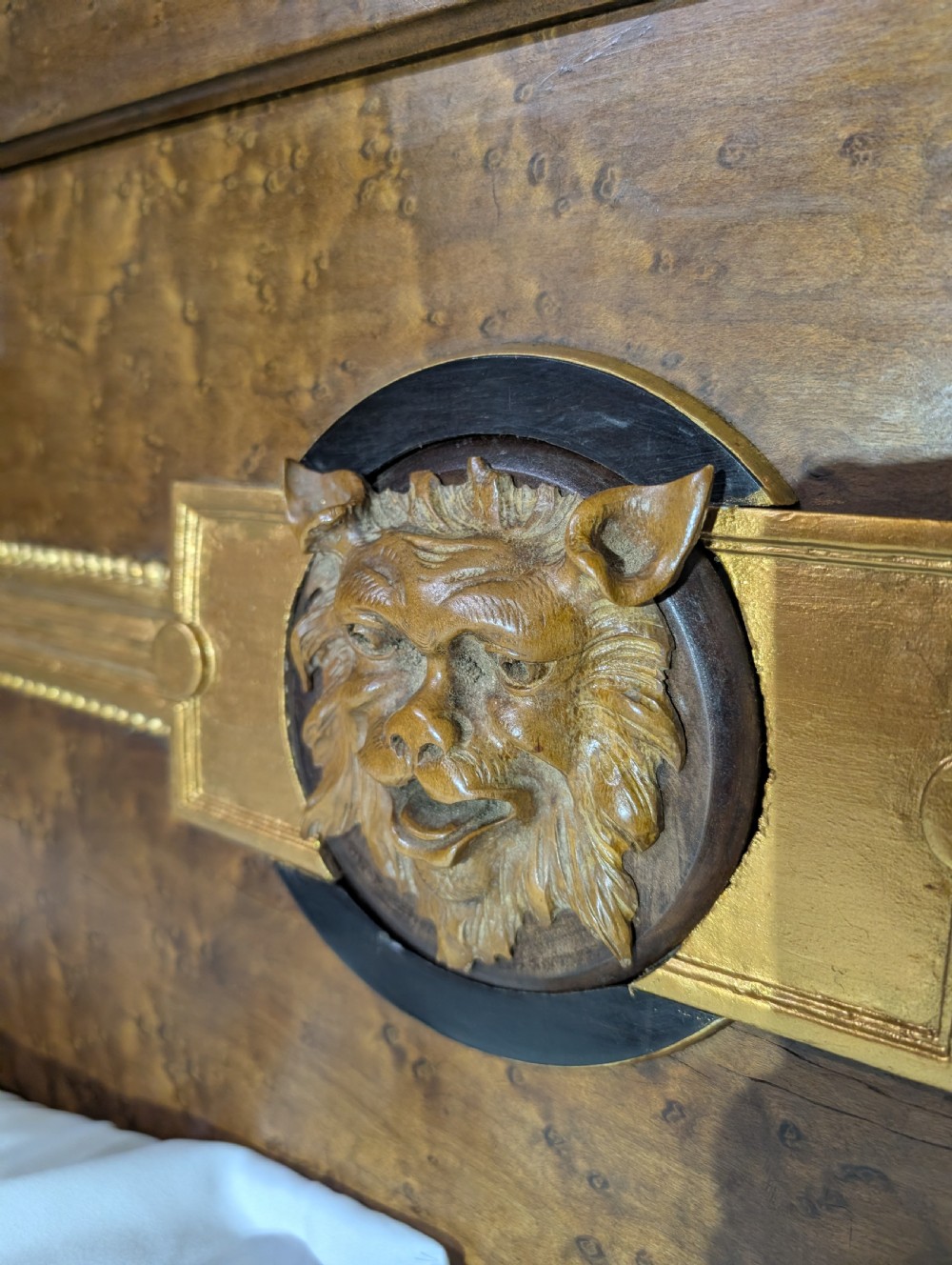 An Empire style king-sized bedstead crafted in golden veneered wood with gilt mounts and a Greek key border along the footboard base. View XVI