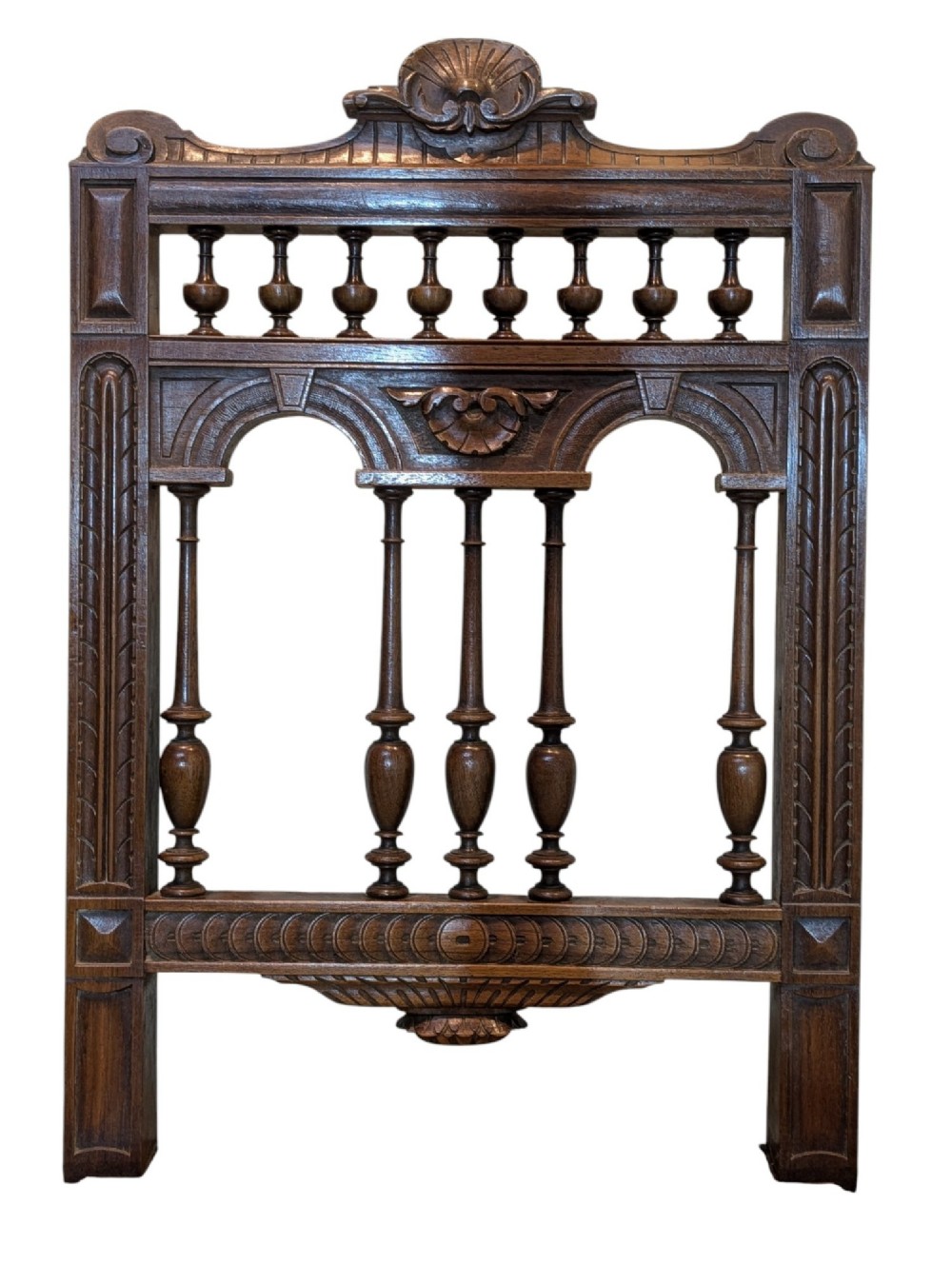A set of four antique dark carved oak dining chairs featuring openwork spindle backs and woven cane seats. View VI