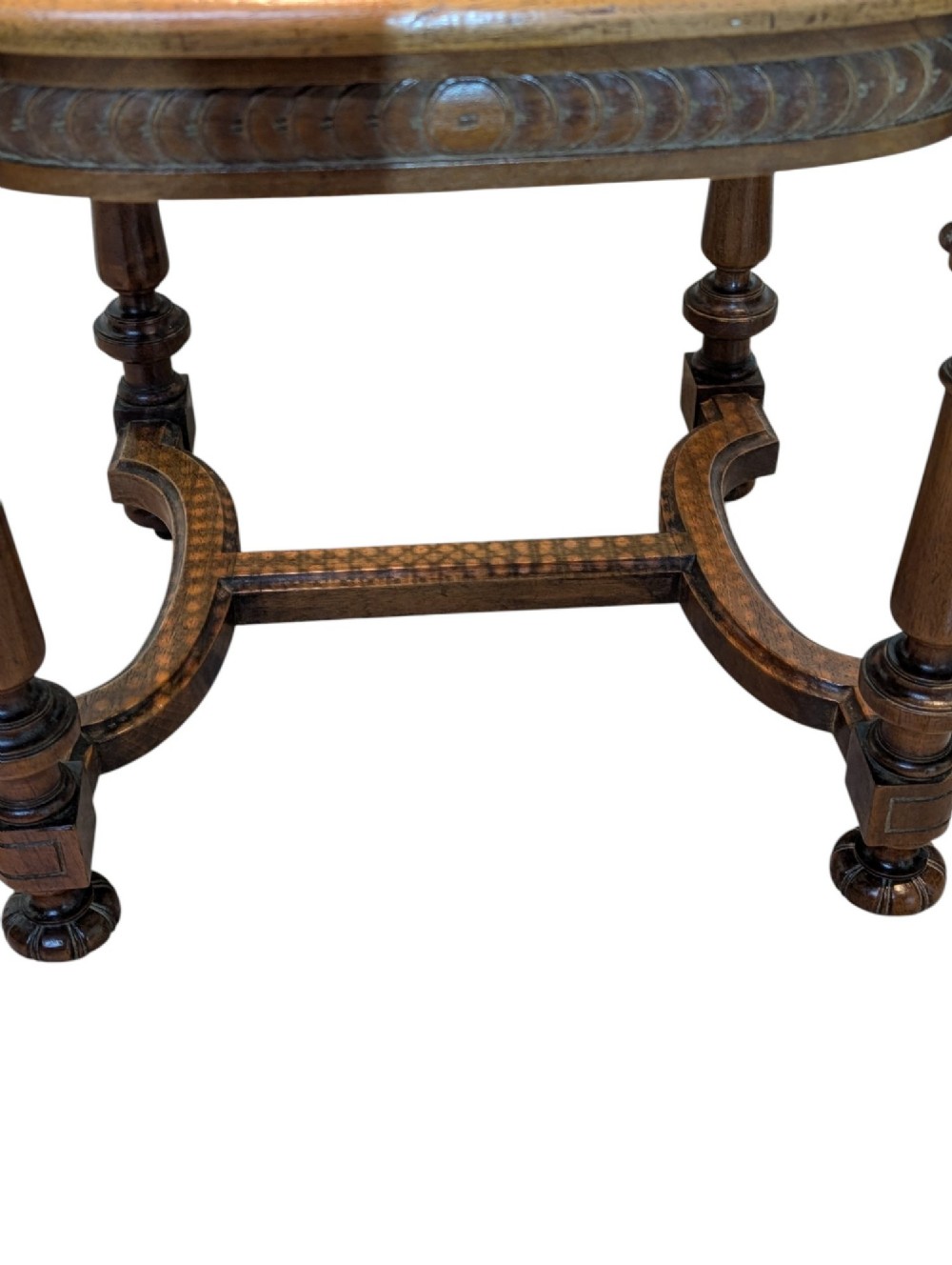 A set of four antique dark carved oak dining chairs featuring openwork spindle backs and woven cane seats. View IX