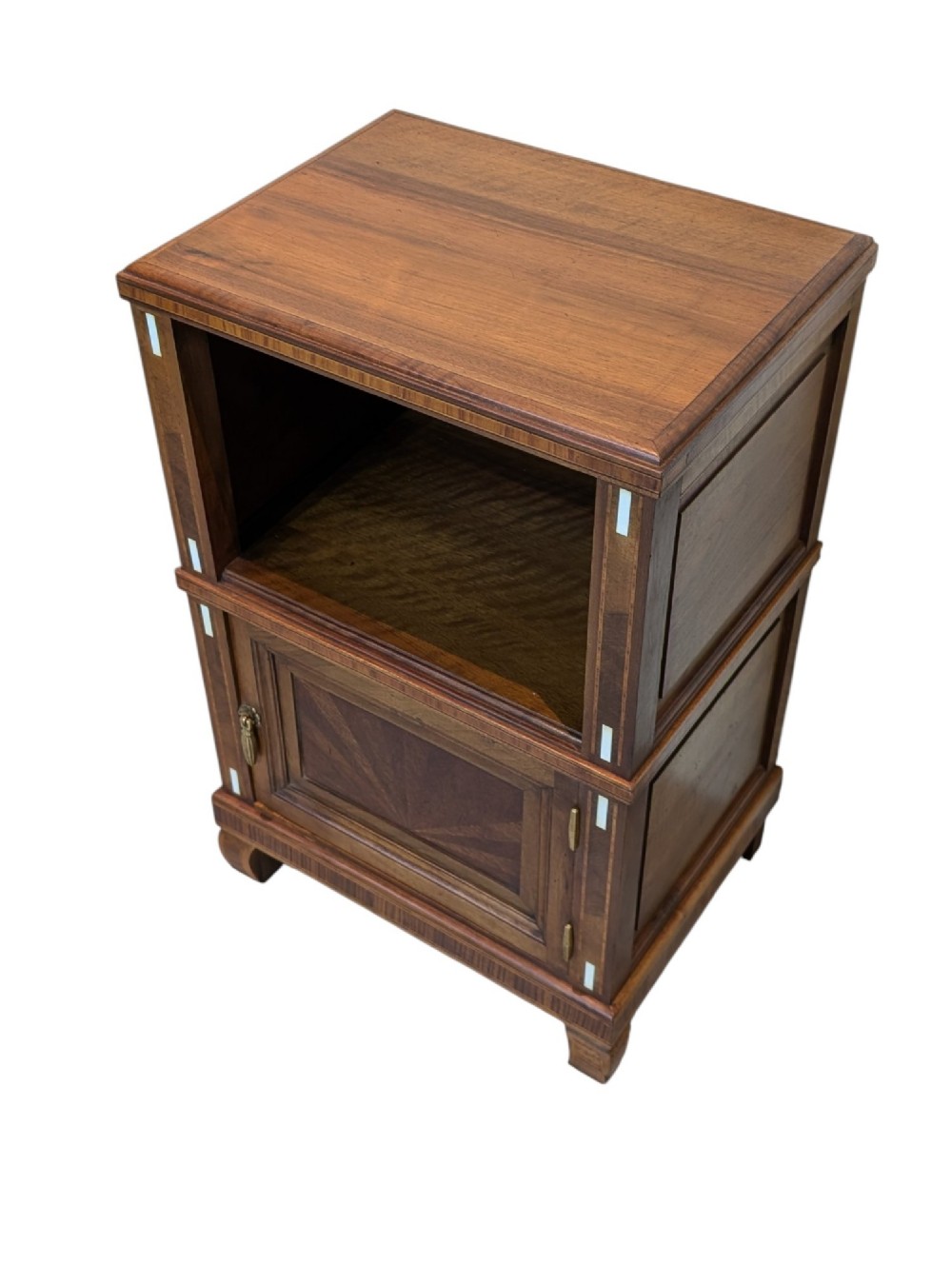 An antique dark wood bedside cabinet featuring an open upper compartment, a lower single door cupboard with marquetry detail, white line inlays, and short curved legs. View VIII