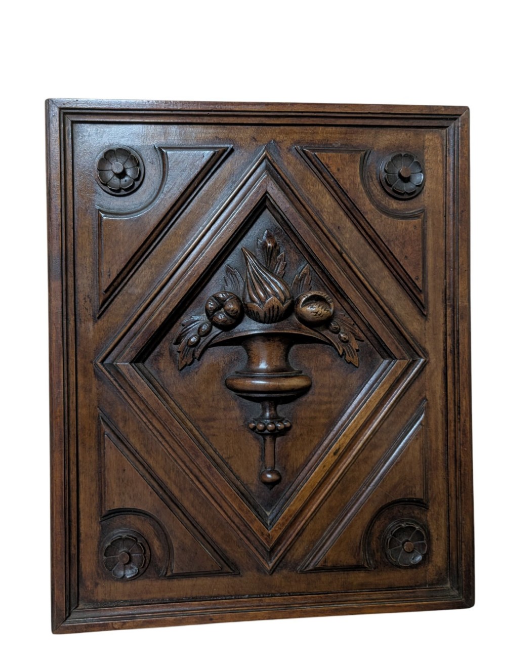 A pair of dark oak rectangular carved panels featuring central urn motifs enclosed by geometric diamond mouldings and corner floral rosettes. View II