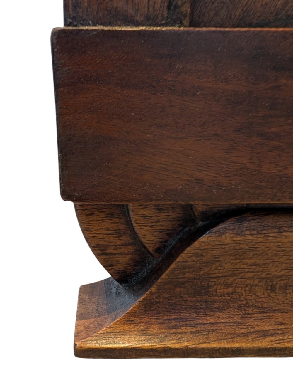 A dark brown walnut Art Deco bedside cabinet featuring a top drawer, an open central shelf, a cupboard door with geometric veneer inlay, and hexagonal metal knobs. View VI