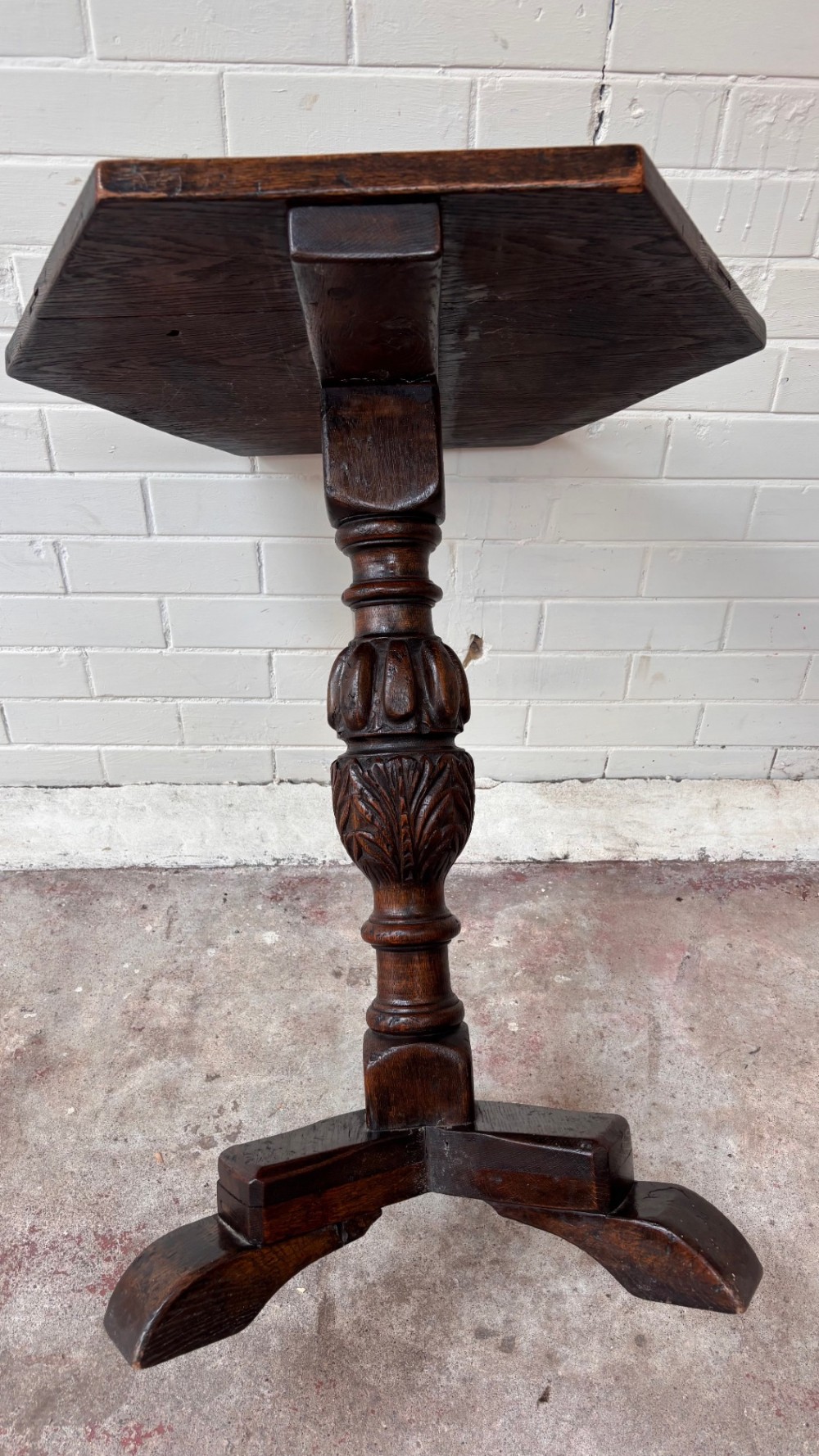 A dark oak pedestal side table featuring a hexagonal top resting on a carved central stem with tripod legs. View IV