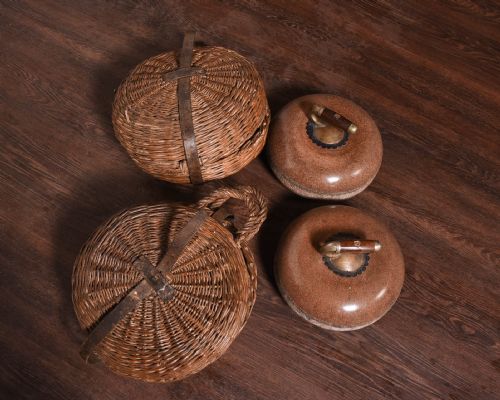 Rare Pair of Red Granite Curling Stones with Original Carrying Baskets