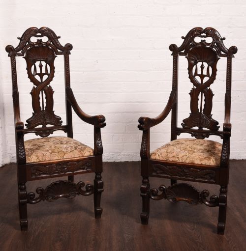 A Stunning Pair of Carved Oak Arm Chairs