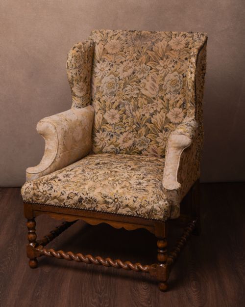 An Upholstered Oak Barley Twist Wing Arm Chair