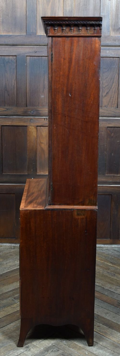 A tall Georgian mahogany secretaire bookcase featuring an upper two-door cabinet with oval inlay panels above a lower chest with four drawers and brass swan-neck handles. View IX