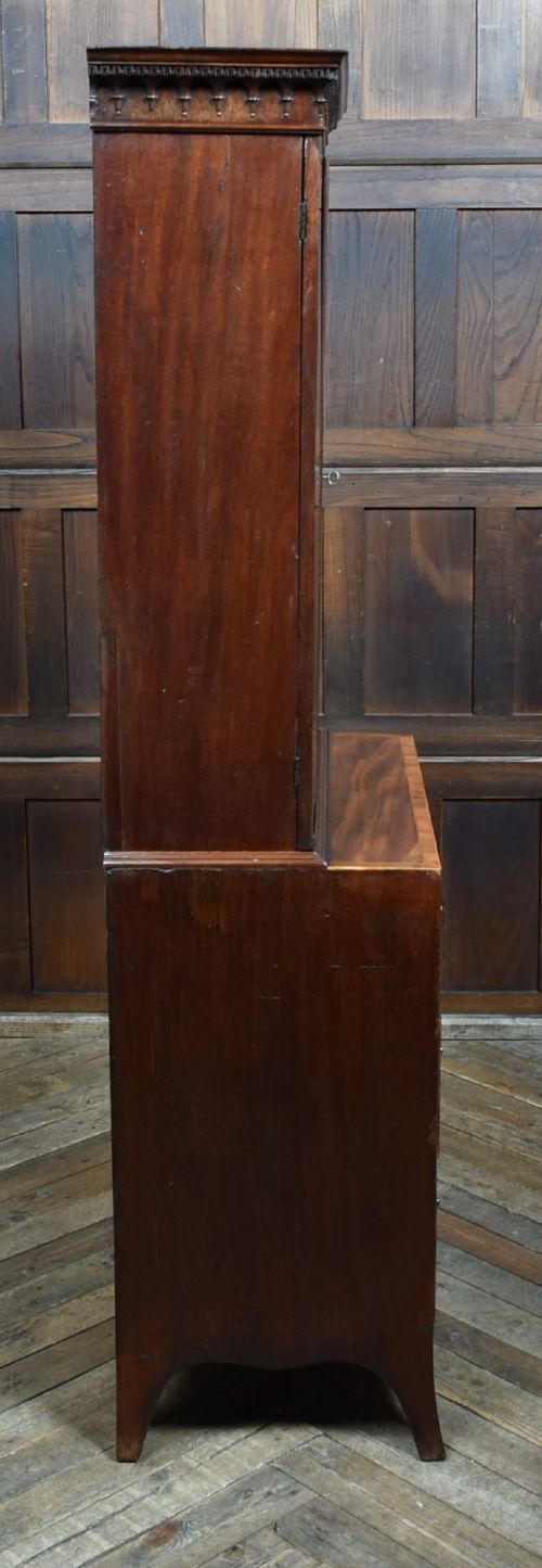A tall Georgian mahogany secretaire bookcase featuring an upper two-door cabinet with oval inlay panels above a lower chest with four drawers and brass swan-neck handles. View XI