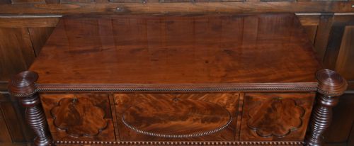fig 1. A Victorian mahogany secretaire cabinet featuring Gothic arch decorative panels, turned columns on either side, and flame mahogany veneers.