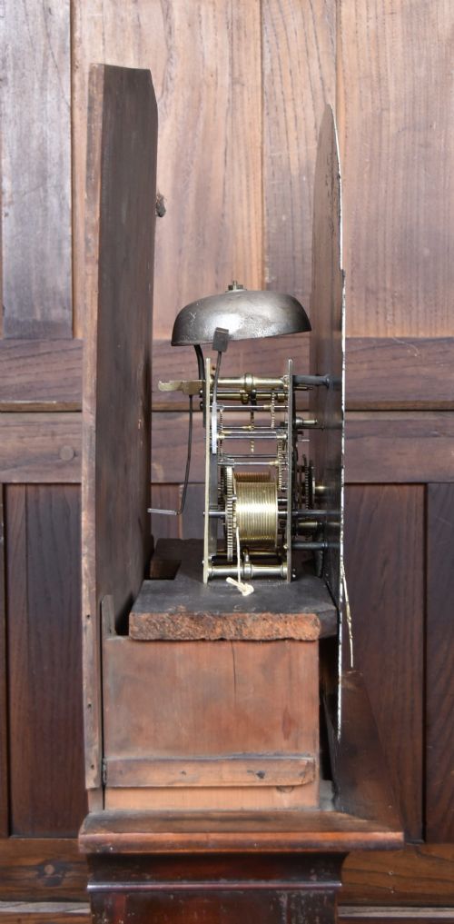 A Scottish mahogany longcase clock featuring a swan-neck pediment with brass finials, a hand-painted dial face, and flame mahogany veneers. View XII