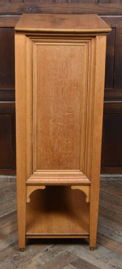 An Edwardian light oak filing cabinet with five stacked fall-front drawers featuring brass ring pulls, supported on square legs with a lower open shelf. View XII