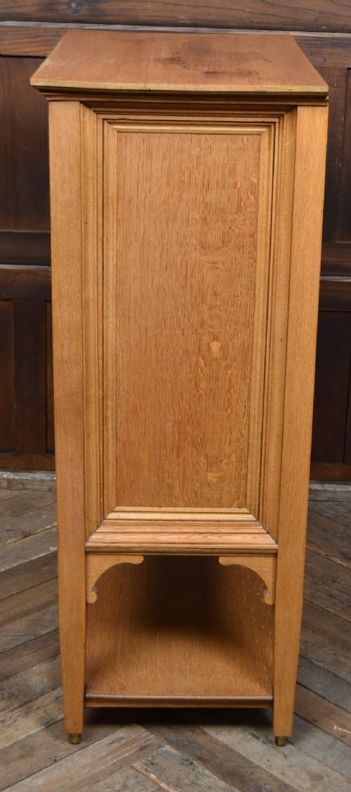 An Edwardian light oak filing cabinet with five stacked fall-front drawers featuring brass ring pulls, supported on square legs with a lower open shelf. View XIV