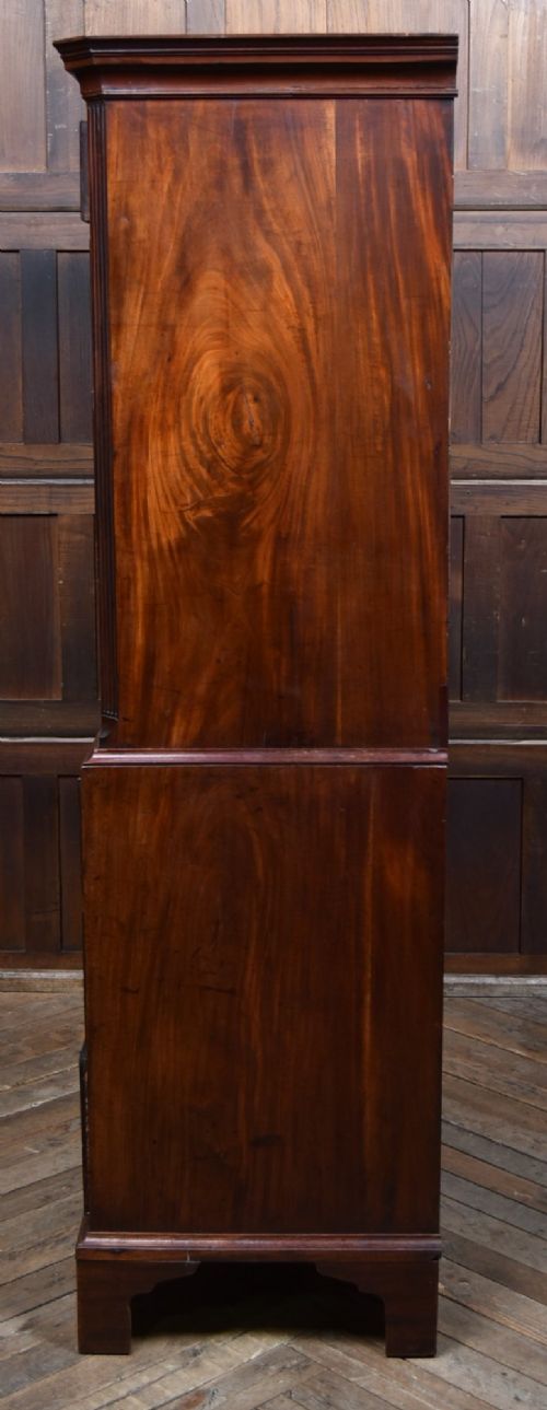 A tall Georgian mahogany chest on chest featuring two stacked tiers of drawers with brass swan-neck handles resting on bracket feet. View XII