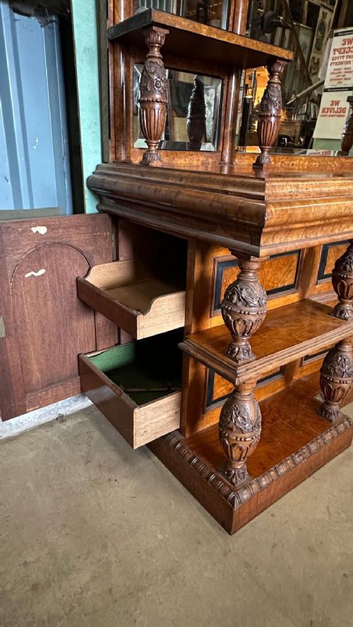 A large Victorian pollard oak mirror-back sideboard featuring carved urn finials, central mirror glass, open side shelving, and ebonised drawer borders. View VII