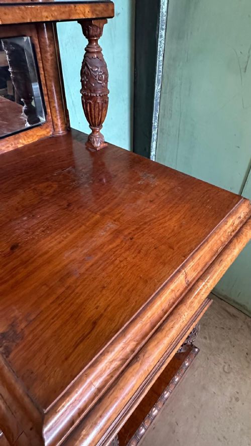 A large Victorian pollard oak mirror-back sideboard featuring carved urn finials, central mirror glass, open side shelving, and ebonised drawer borders. View X