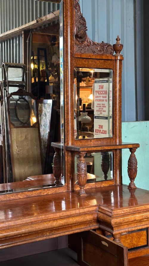 A large Victorian pollard oak mirror-back sideboard featuring carved urn finials, central mirror glass, open side shelving, and ebonised drawer borders. View XII