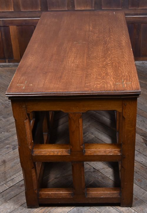 A Victorian oak church communion table with carved Gothic arch panels and a carved inscription reading Do this in Remembrance of me along the top frieze. View XIV