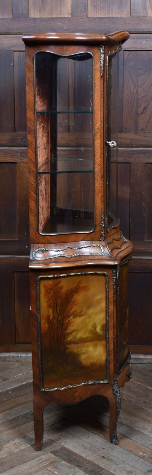 A French walnut vitrine cabinet featuring curved glass upper panels, gilt-bronze ormolu mounts, cabriole legs, and a hand-painted lower door panel depicting a figurative scene. View XI