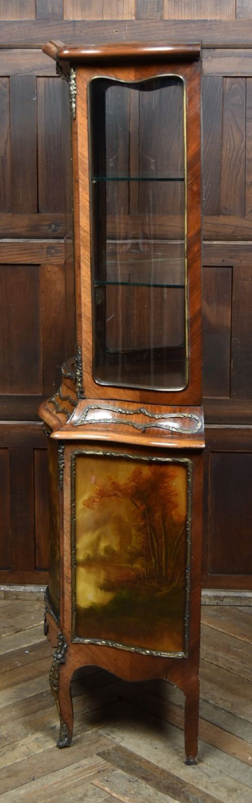 A French walnut vitrine cabinet featuring curved glass upper panels, gilt-bronze ormolu mounts, cabriole legs, and a hand-painted lower door panel depicting a figurative scene. View XIV