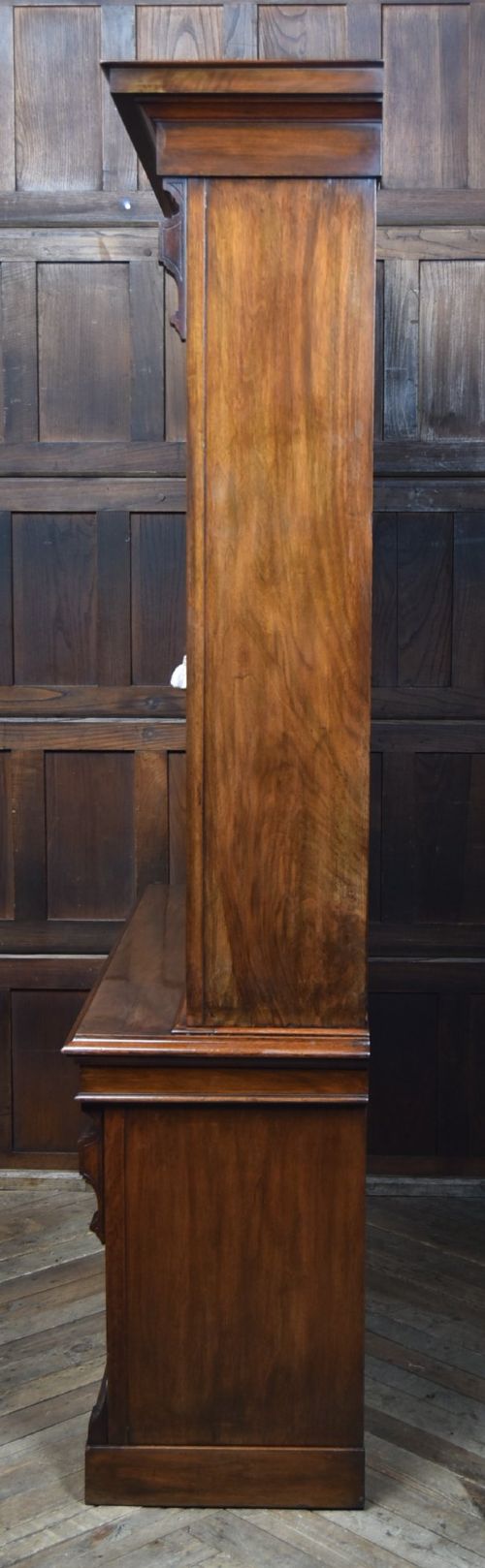 An Edwardian walnut glazed bookcase featuring a two-door upper section with glass panels, adjustable interior shelving, and a lower cabinet with burr walnut door panels. View XIV
