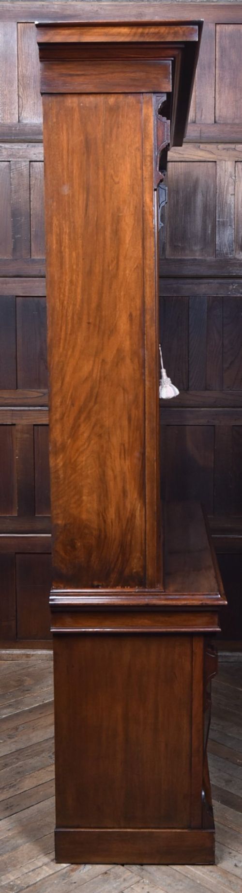 An Edwardian walnut glazed bookcase featuring a two-door upper section with glass panels, adjustable interior shelving, and a lower cabinet with burr walnut door panels. View XV