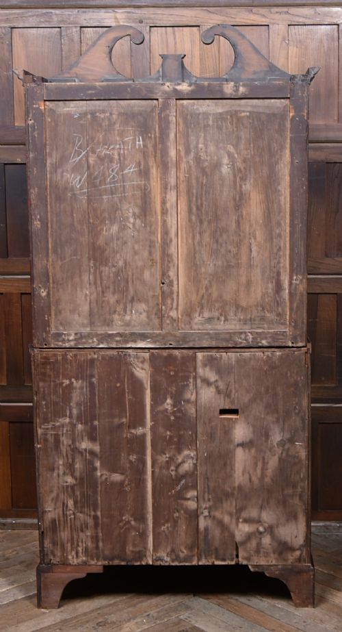 An early nineteenth-century mahogany secretaire bookcase featuring a swan-neck pediment, astragal glazed upper doors, and a lower chest of drawers with brass lion-head handles. View XI