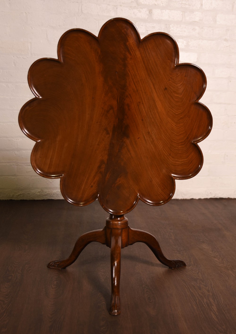 A mahogany tilt top tripod table 