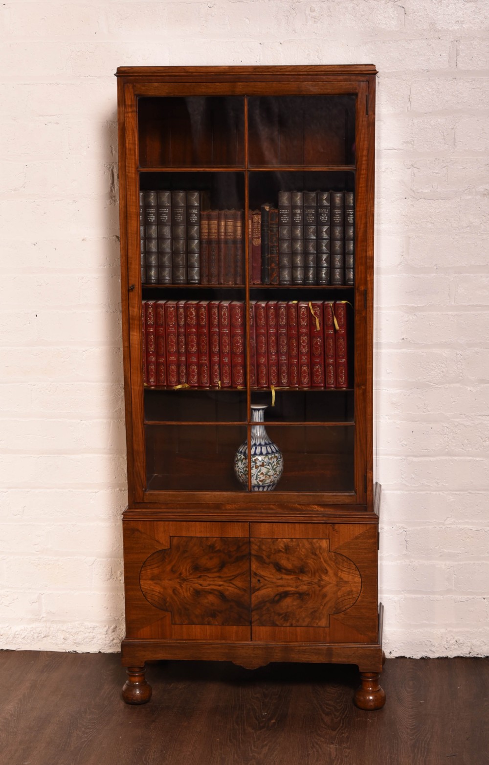 A neat Walnut single door glazed bookcase 