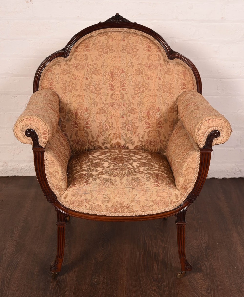An unusual mahogany framed embroidered arm chair 