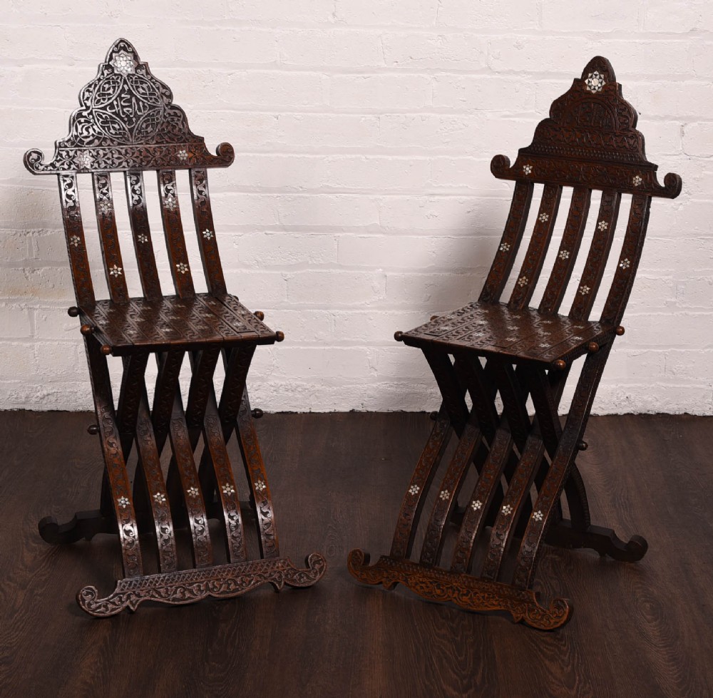 A rare pair late 19th century Islamic carved folding chairs 