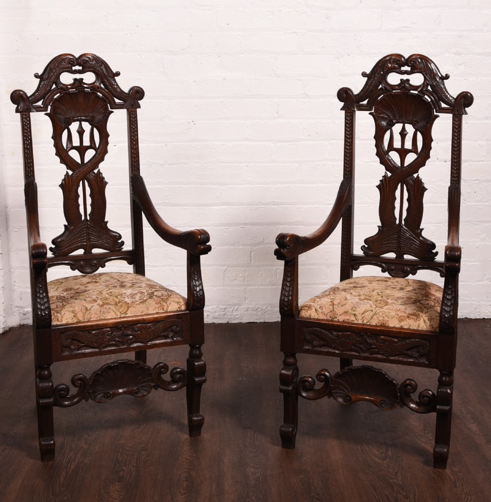 A stunning pair of carved oak arm chairs 