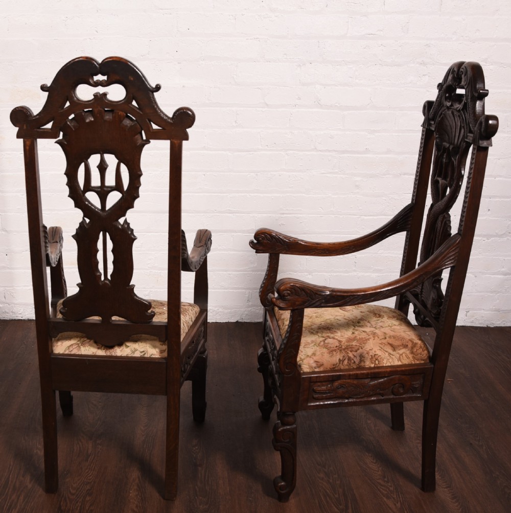 A stunning pair of carved oak arm chairs  View XI
