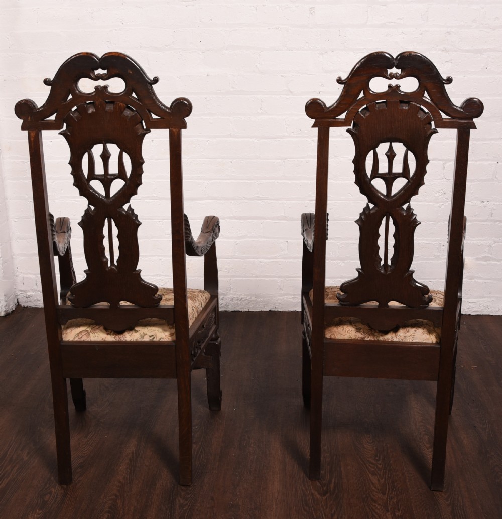 A stunning pair of carved oak arm chairs  View XII