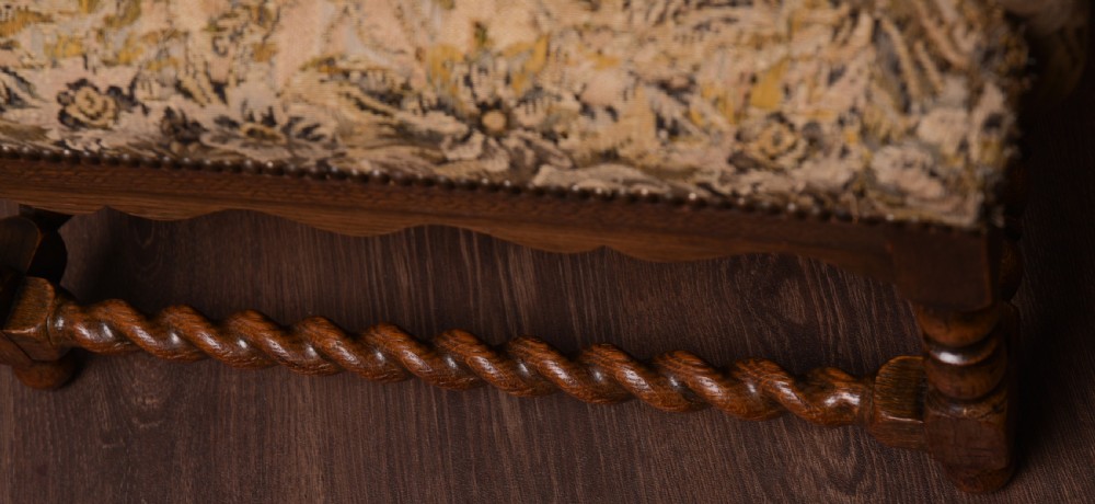 An upholstered oak barley twist wing arm chair View II