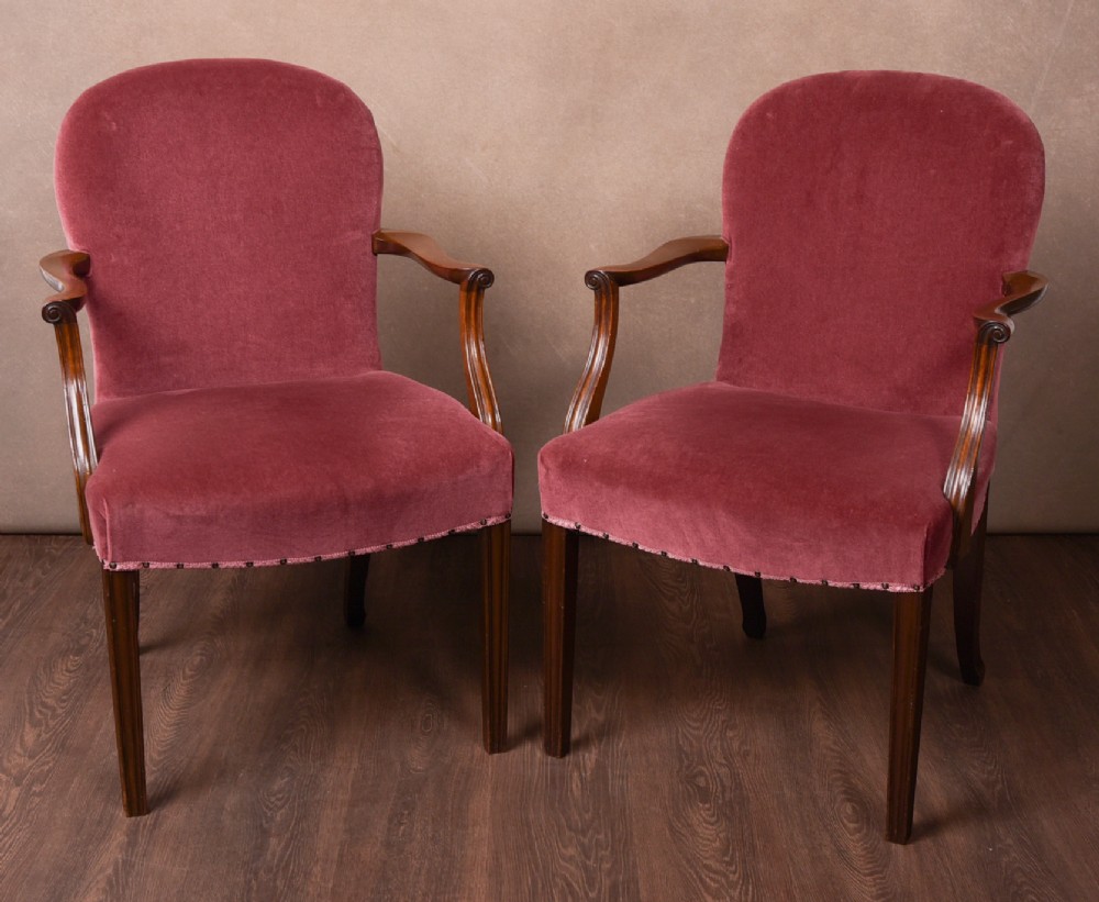 An elegant pair of upholstered elbow desk chairs 