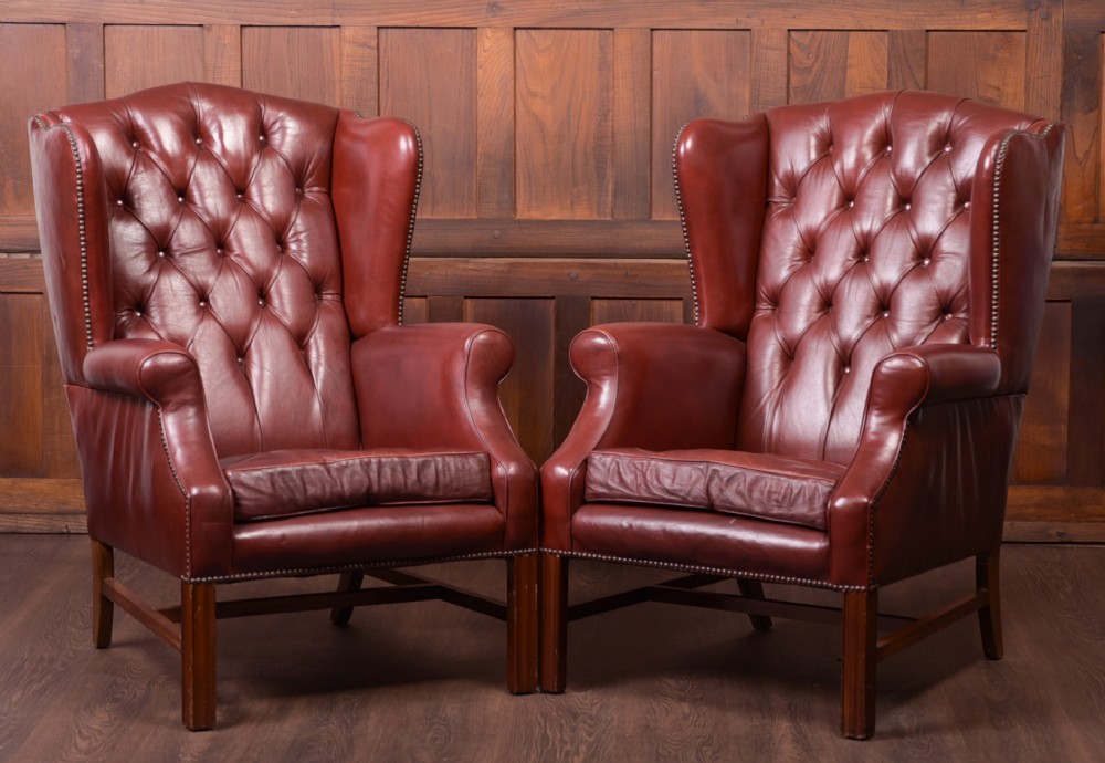 Edwardian Pair of leather Chesterfield wing back chairs 