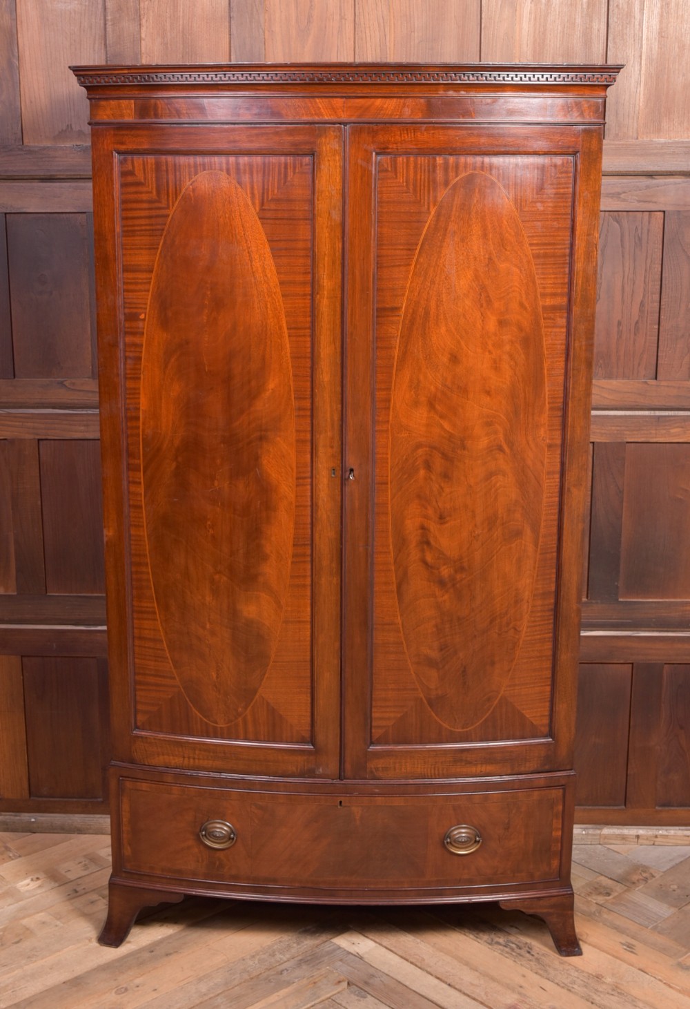 A Neat proportioned Edwardian Mahogany bow fronted wardrobe 