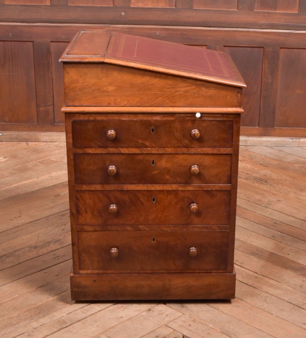 A Victorian walnut Davenport desk featuring a slanted burgundy leather writing surface, side drawers with wooden knobs, and a solid rectangular base. View XII