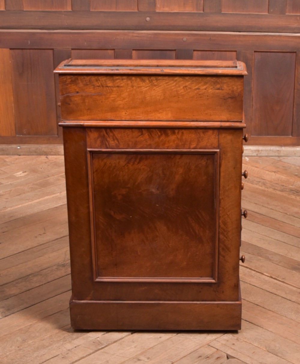 A Victorian walnut Davenport desk featuring a slanted burgundy leather writing surface, side drawers with wooden knobs, and a solid rectangular base. View XIII