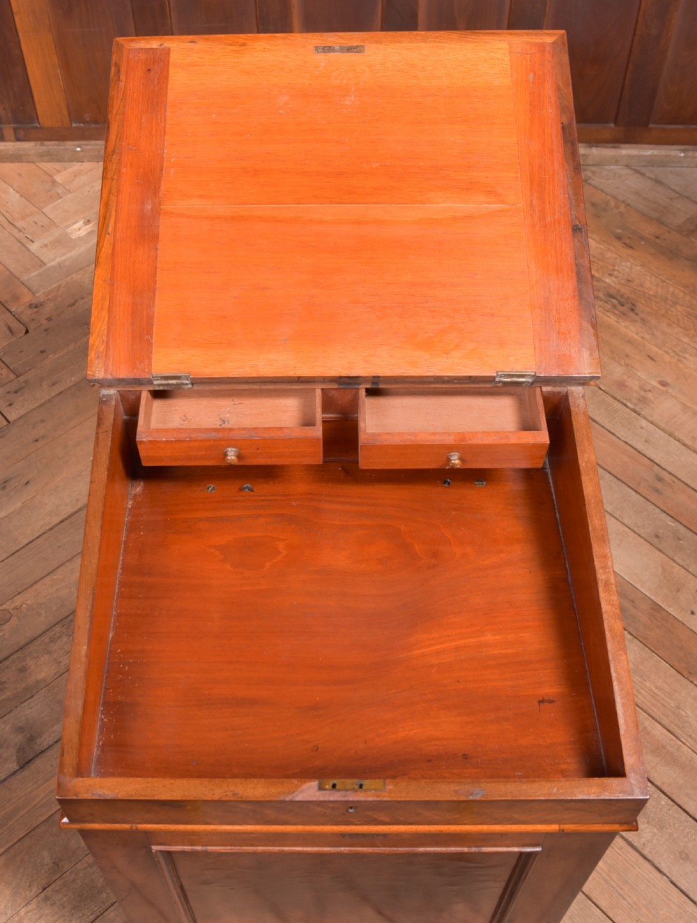 A Victorian walnut Davenport desk featuring a slanted burgundy leather writing surface, side drawers with wooden knobs, and a solid rectangular base. View XVIII