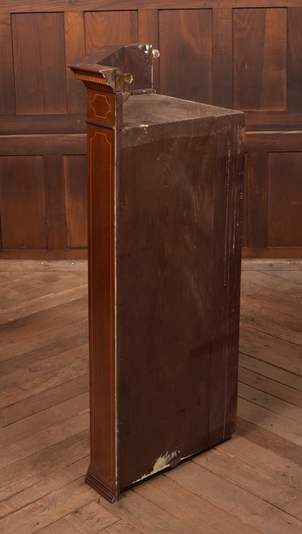 An Edwardian mahogany corner cabinet featuring astragal glazed glass panels, geometric boxwood line inlay, and internal timber shelves. View VIII