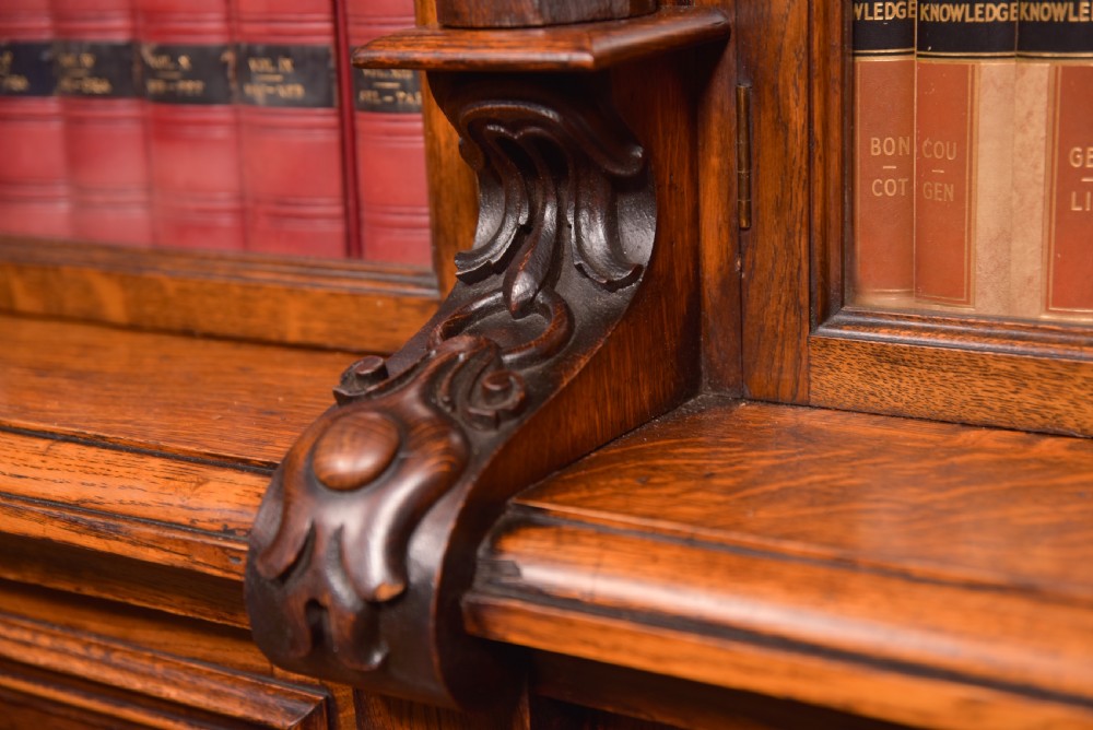 A large Victorian oak bookcase featuring glazed upper doors flanked by barley twist columns with turned finials above carved diamond panel doors. View X